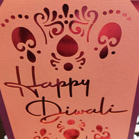 Handmade Diwali card featuring intricate cut-out design and 'Happy Diwali' greeting for festival gifting.