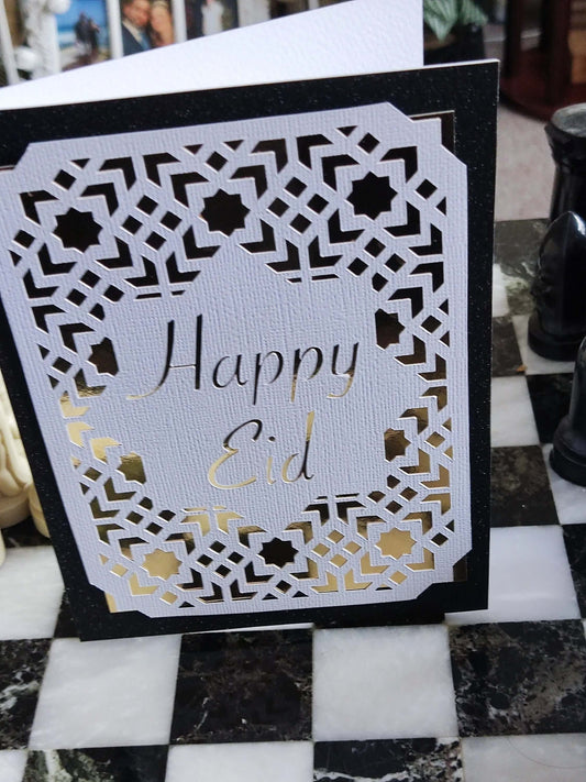 Eid card featuring a laser-cut Islamic geometric design with the message 'Happy Eid' in elegant gold lettering.