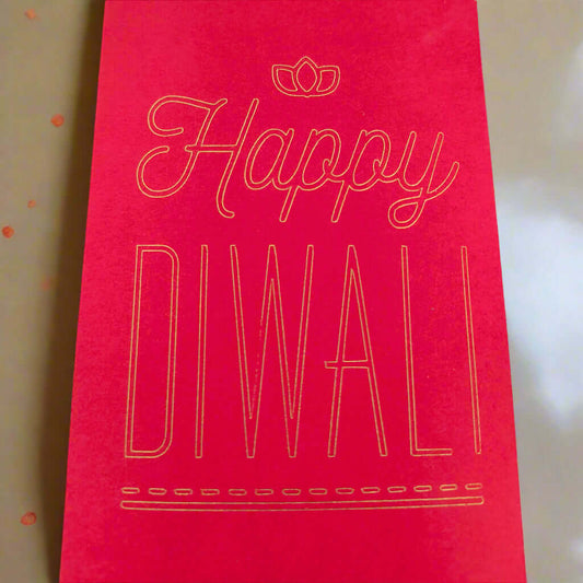 Red Diwali money envelope with gold foil-style text that reads 'Happy Diwali' in elegant lettering, placed on a soft cream and gold-toned background.