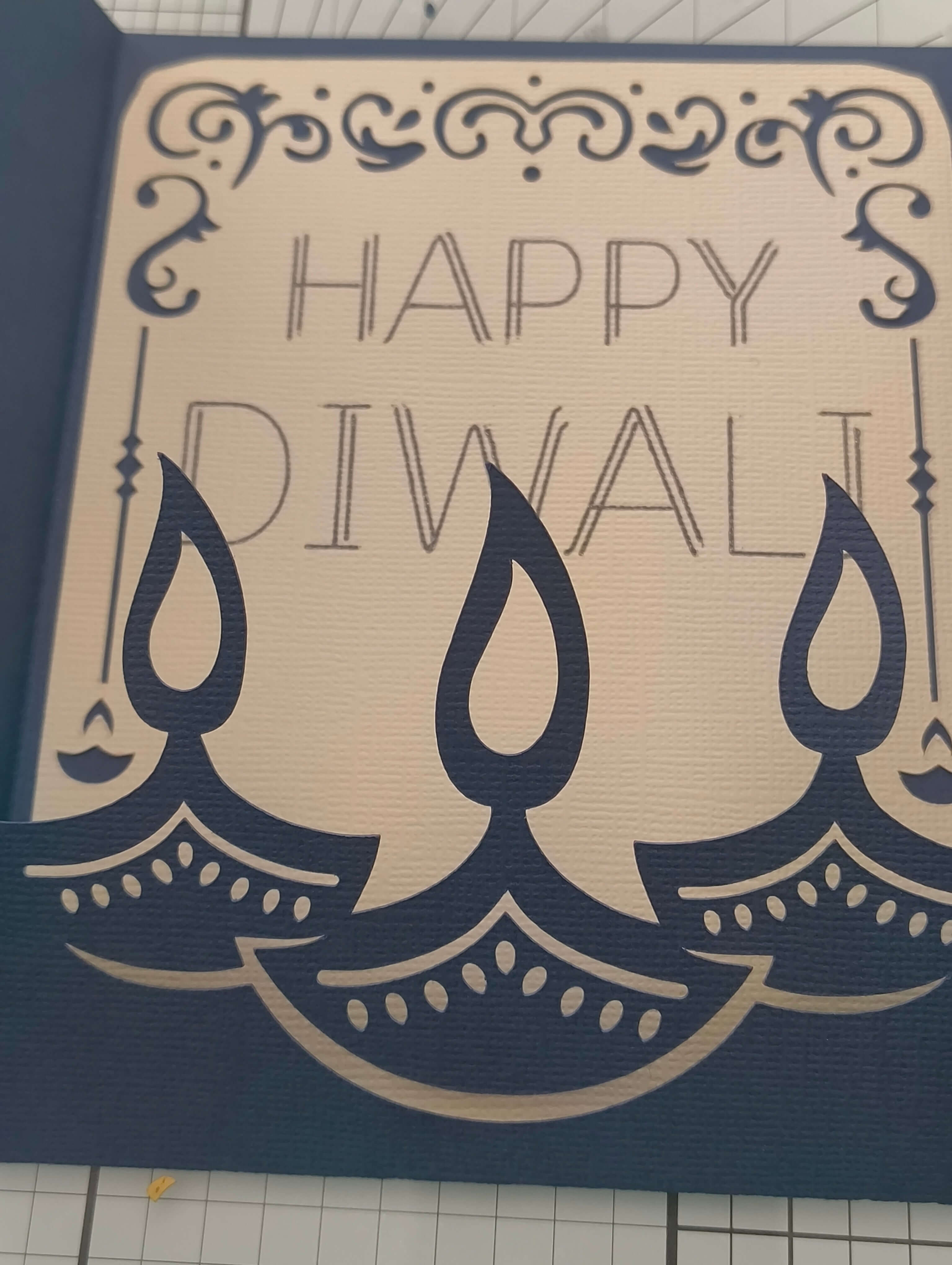 Handmade Diwali card featuring layered navy lamps and the greeting 'Happy Diwali' for festive celebrations.
