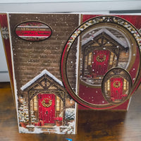 Handmade Christmas card featuring a cozy snow-covered door with a decorative wreath.