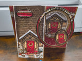 Handmade Christmas card featuring a cozy snow-covered door with a decorative wreath.