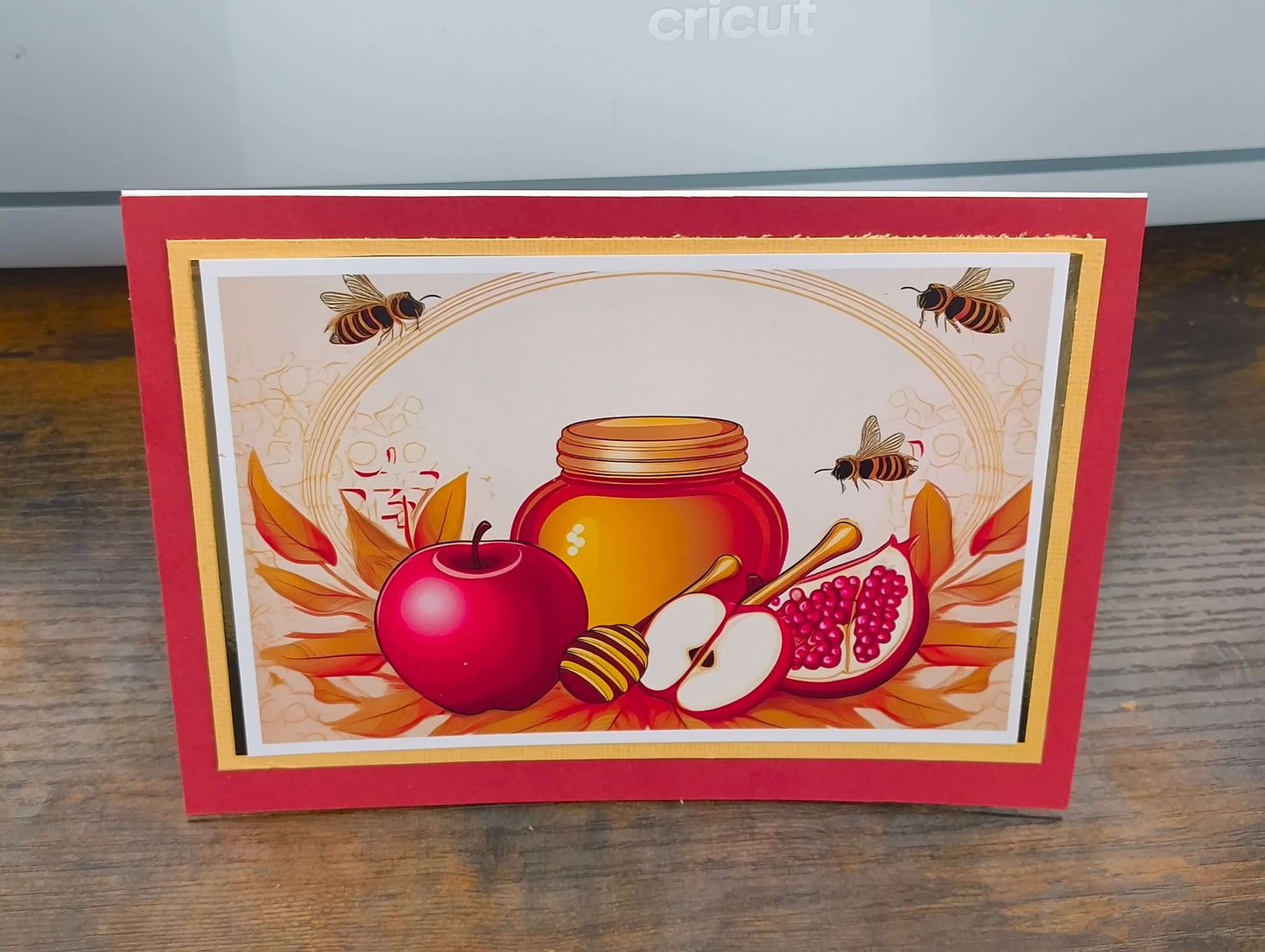 Vibrant Rosh Hashanah card with honey, apples, and pomegranates, celebrating the Jewish New Year.