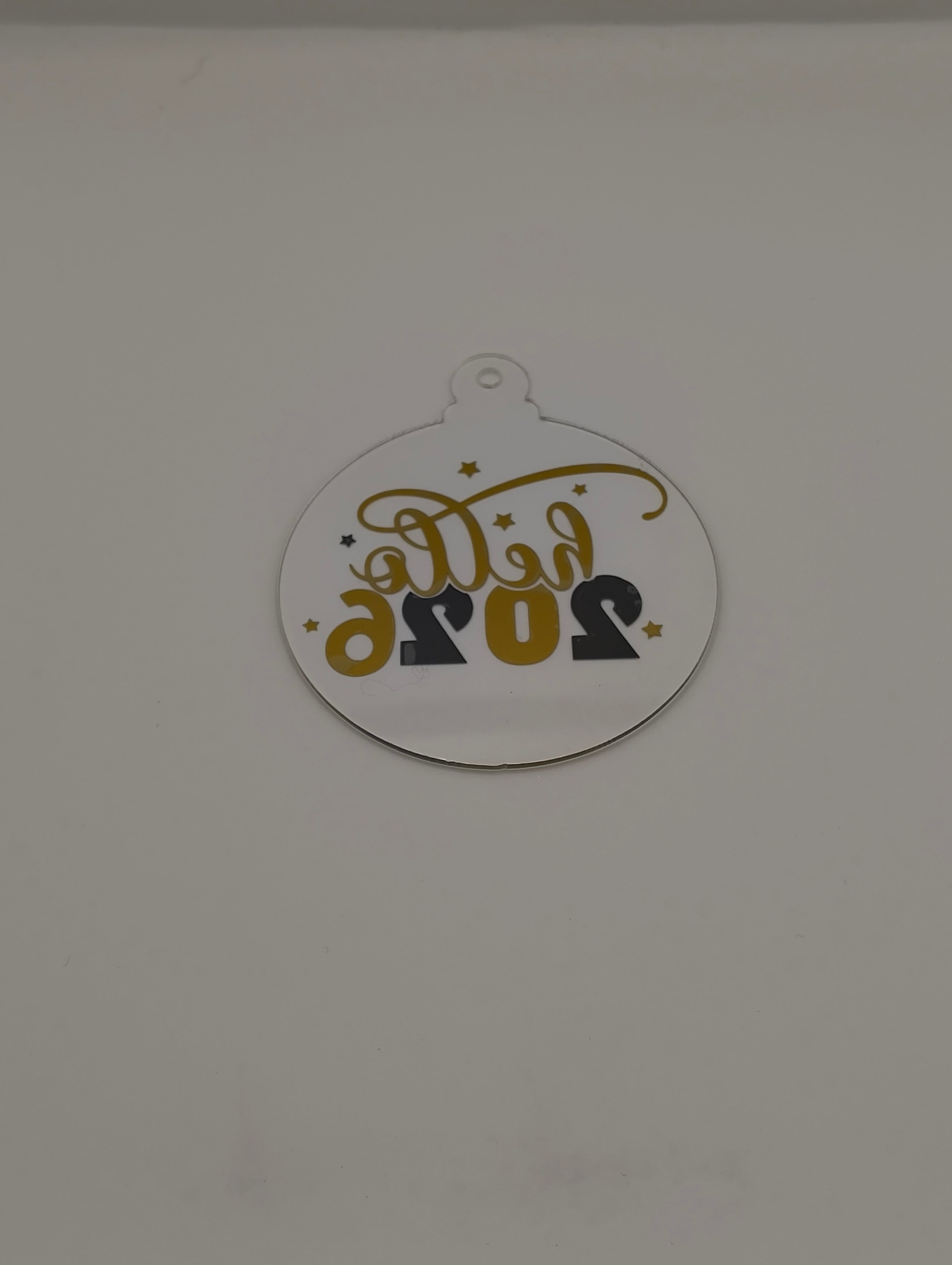 2026 New Year bauble ornament with decorative text and stars design for festive celebrations.