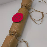 Eco-Friendly Christmas Crackers with gold holly design and jute twine for a rustic festive look.