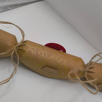 Eco-friendly Christmas crackers with gold holly design and jute twine, perfect for festive celebrations.