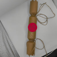 Eco-friendly Christmas crackers with gold accents and jute twine for a rustic festive touch.