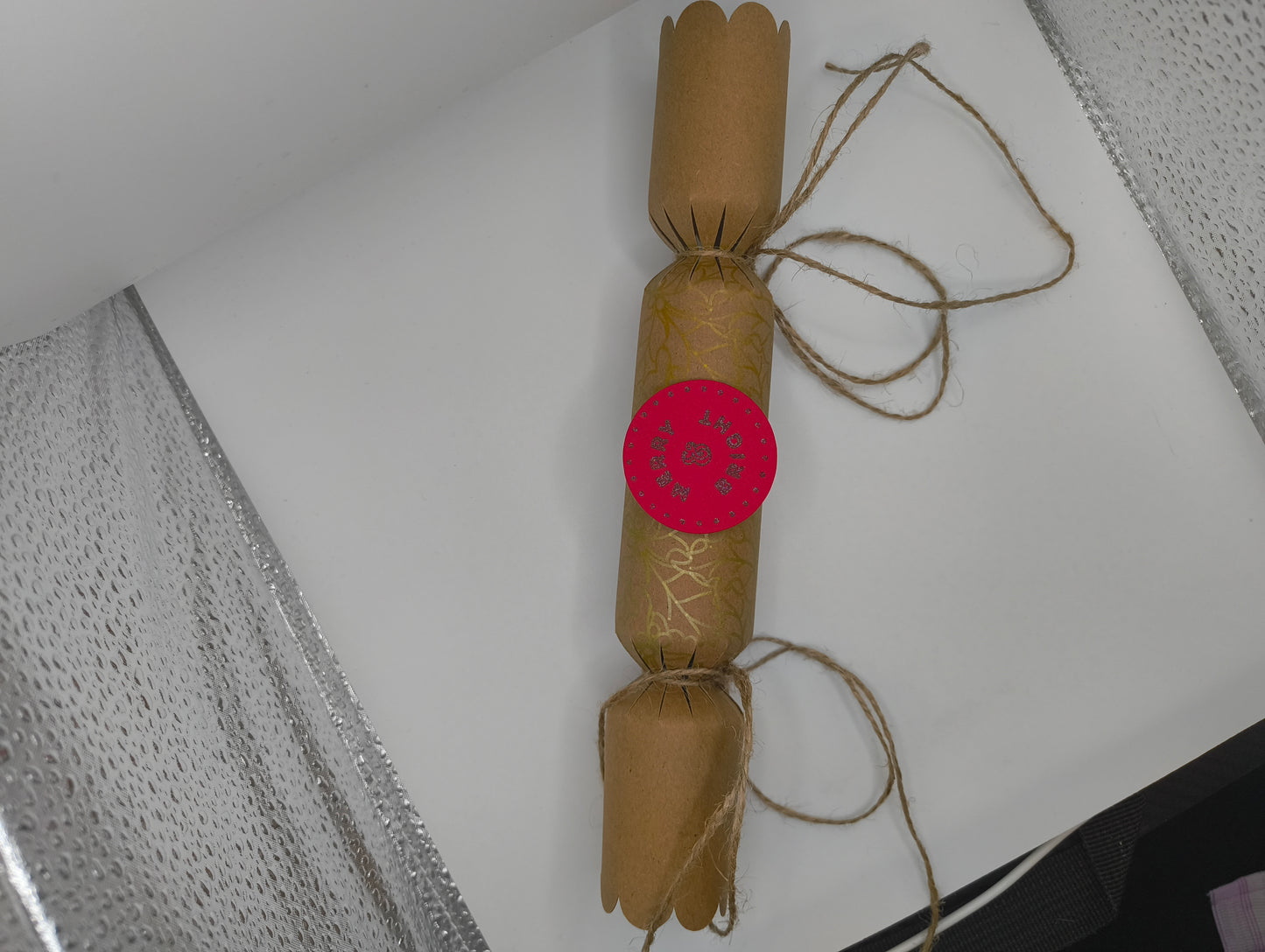Eco-friendly Christmas crackers with gold accents and jute twine for a rustic festive touch.