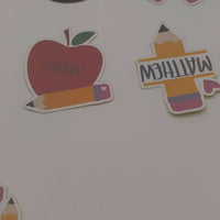 Personalised School Name Stickers showcasing apple, pencil, and name designs for kids' school supplies.