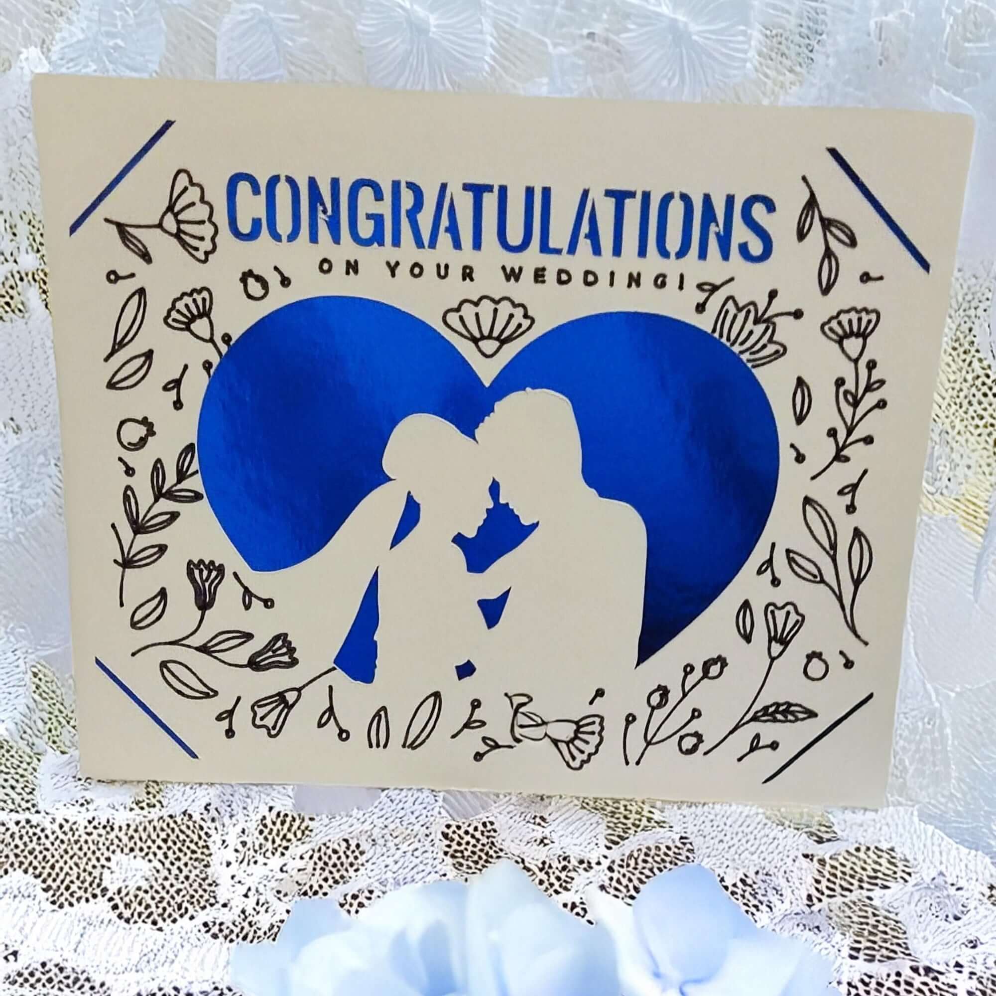 Handmade wedding congratulations card with blue heart and floral design, featuring a romantic silhouette.