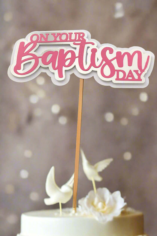 Personalised Baptism cake topper featuring the phrase 'On Your Baptism Day' in pink and white.