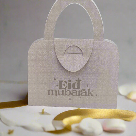 Neutral beige Eid Mubarak handbag money holder with intricate pattern, styled with ribbon and petals for Eid celebrations.