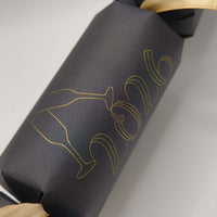 Personalised New Year cracker in black with gold 2016 design and ribbon, perfect for New Year's 2026 celebration.