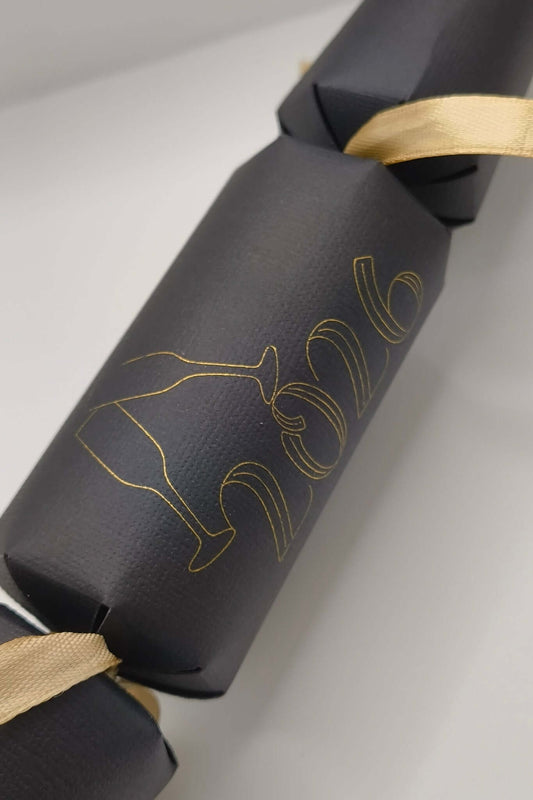 Personalised New Year cracker in black with gold 2016 design and ribbon, perfect for New Year's 2026 celebration.