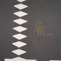 Close-up of black cracker card template showing gold foil witch hat and “Mum” lettering