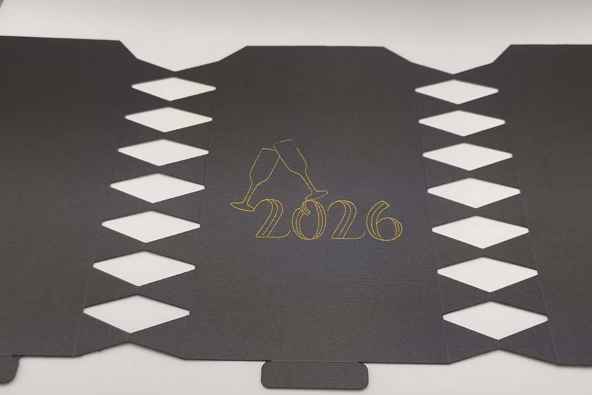 Personalised New Year cracker design featuring 2026 in gold with champagne glasses decoration.