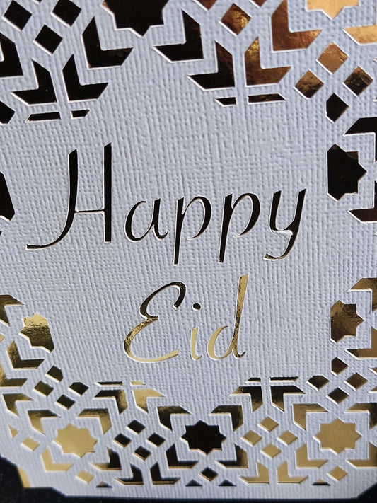 Happy Eid Card featuring intricate laser cut Islamic geometric design in gold and white.