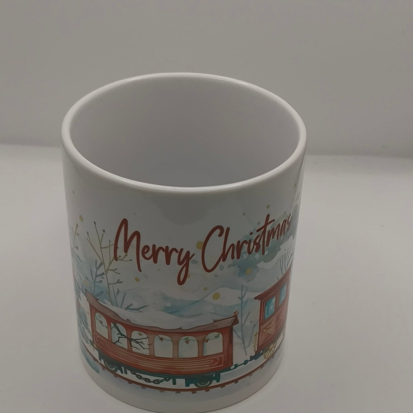 Ceramic Merry Christmas mug with festive train design studio photo