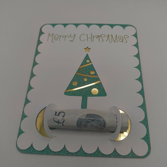 Handmade Christmas money holder card with green glitter border and gold foil Christmas tree, holding a £5 note.