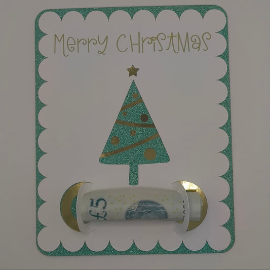 Vertical view of Christmas tree money holder card with rolled £5 note inside gold and white holder.