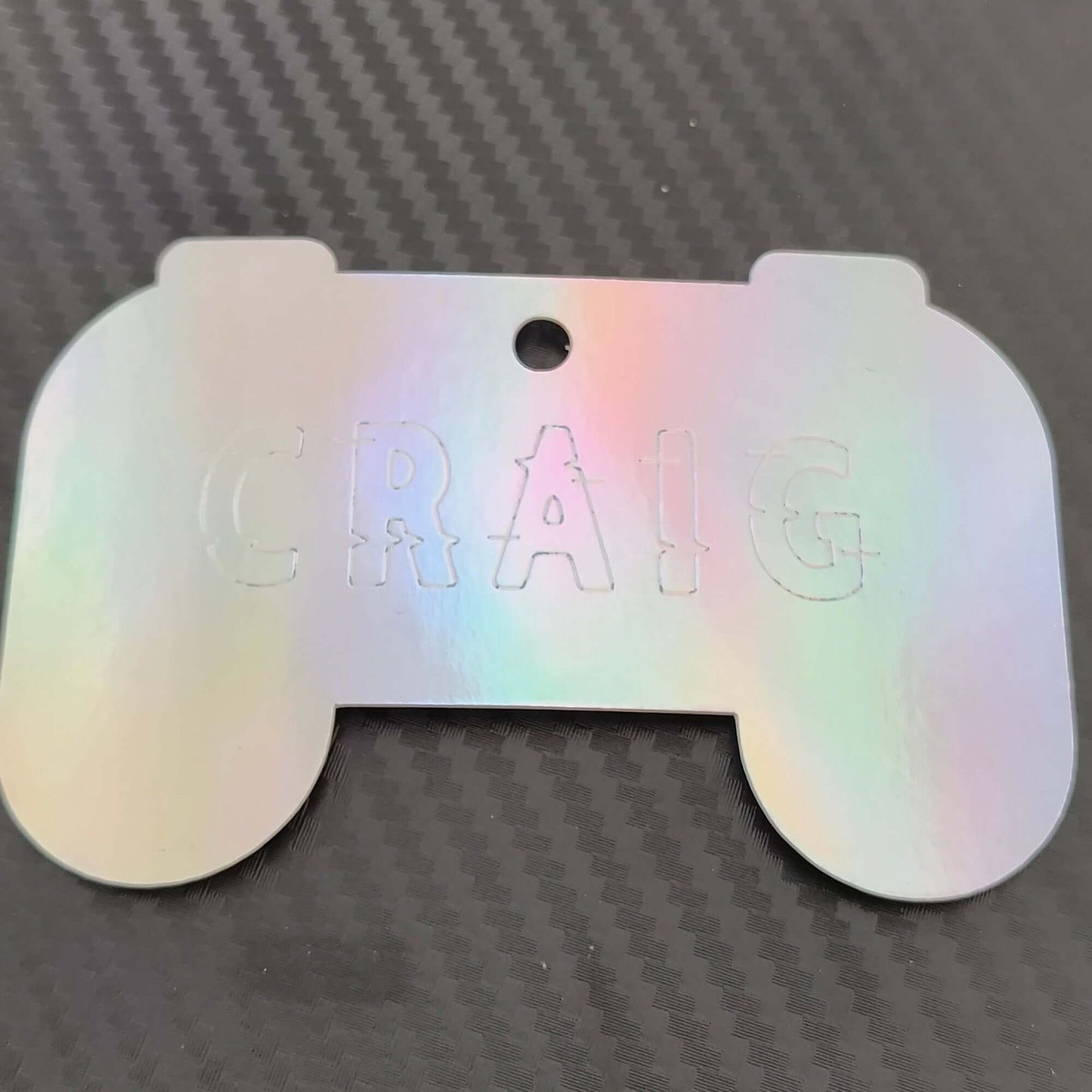 Holographic gaming gift tag shaped like a game controller, personalised with the name 'CRAIG', perfect for gamers.
