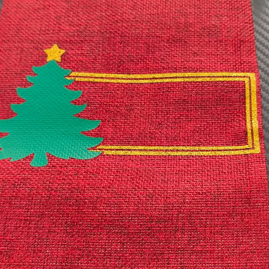 Personalised Christmas wine bottle bag in red hessian with green tree design and gold frame for a custom name.