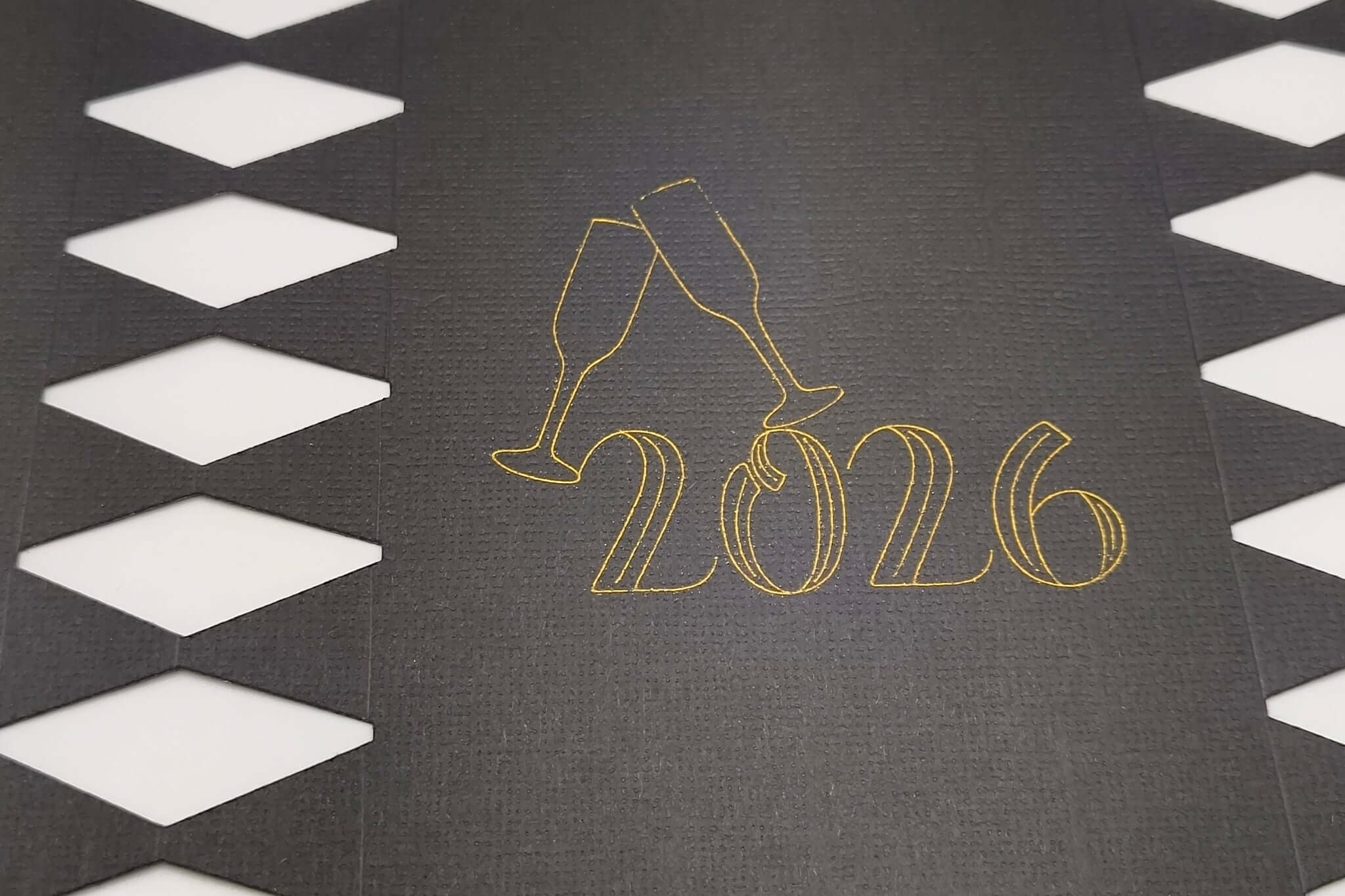 Personalised New Year cracker design featuring 2026 with champagne glasses on a black background.