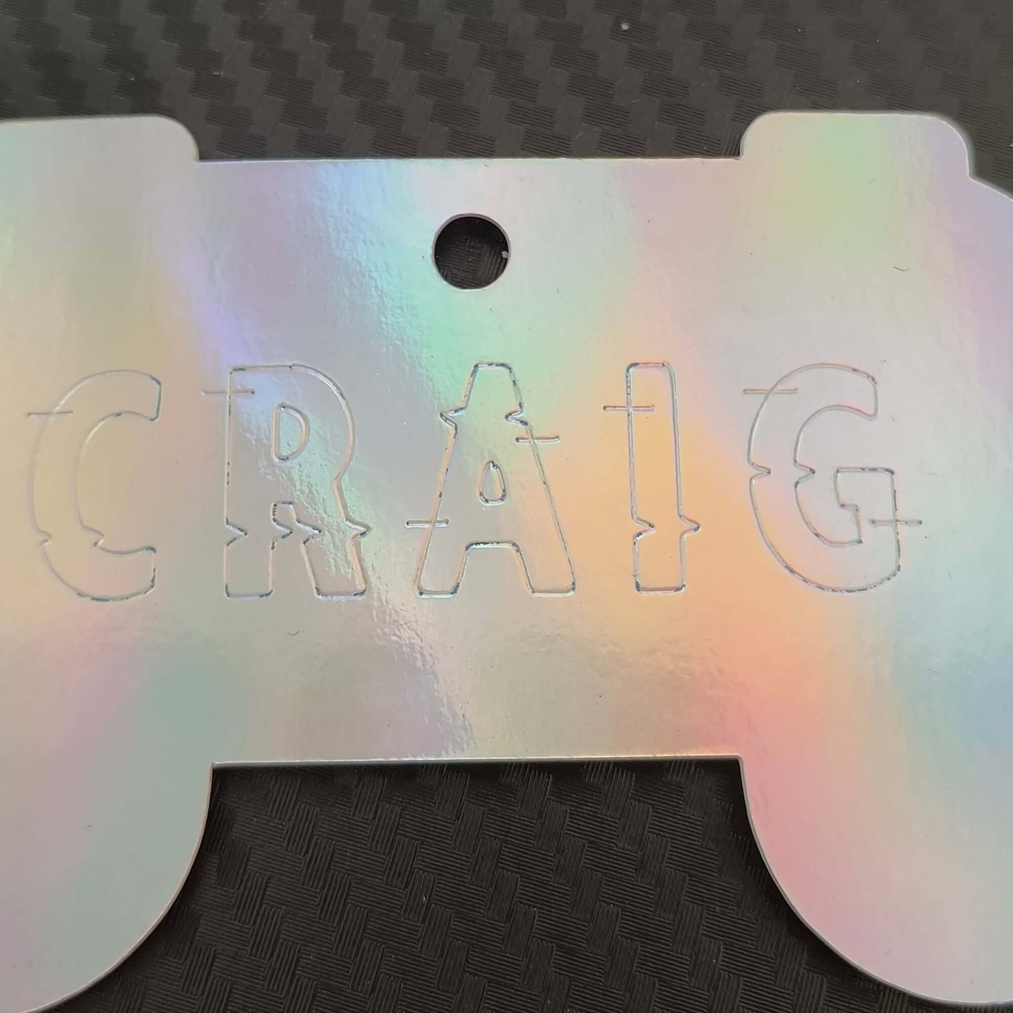 Personalised holographic gaming gift tag with the name CRAIG engraved, perfect for gamers.