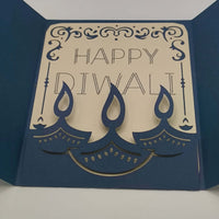 Handmade Diwali card featuring navy blue design with gold accents and layered candles, saying 'Happy Diwali' inside.