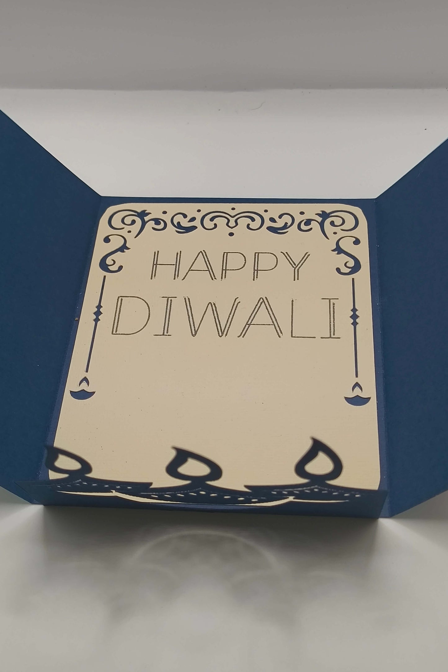 Handmade Diwali card with navy blue design and the greeting 'Happy Diwali' inside, perfect for festive celebrations.