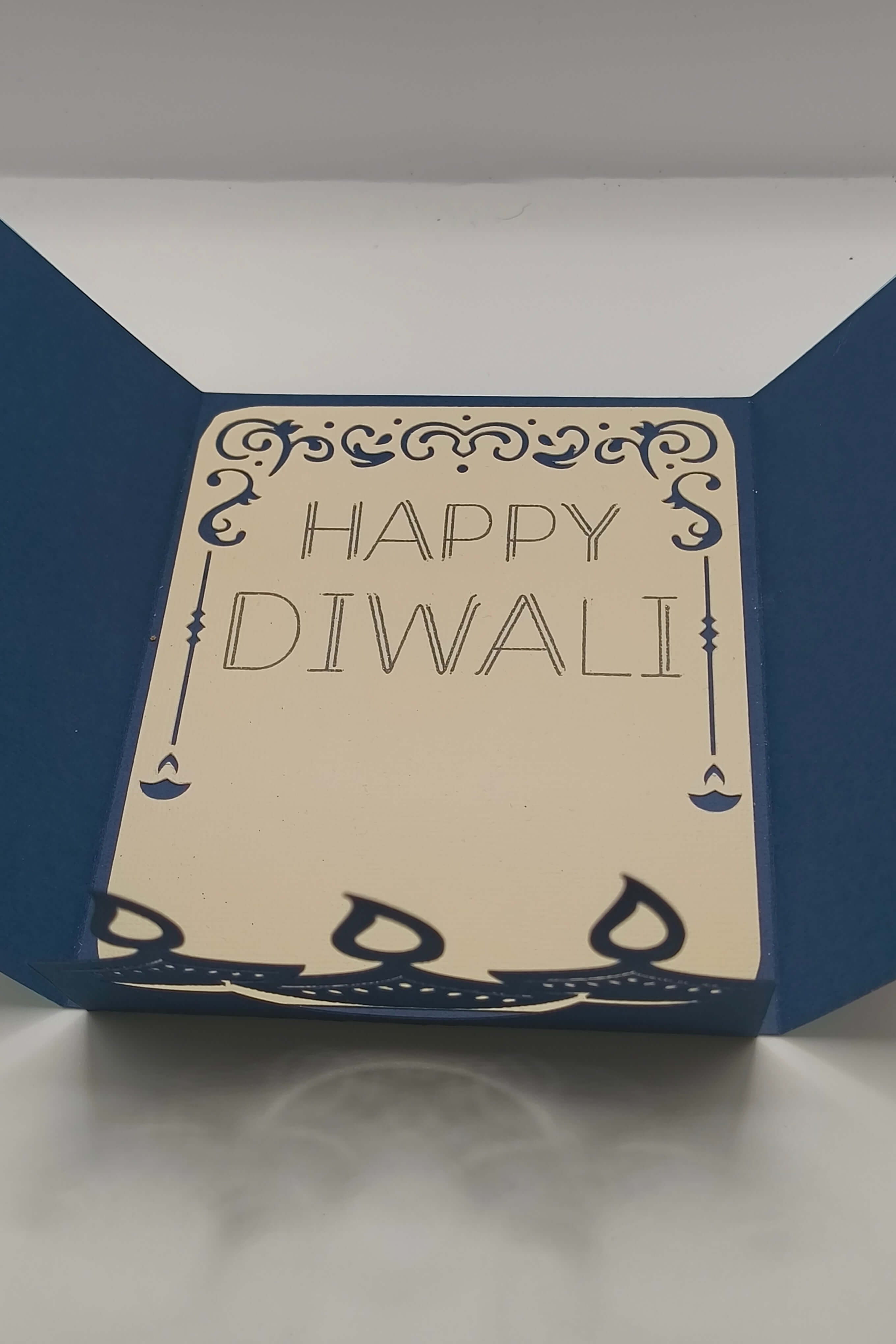 Handmade Diwali card with navy blue design and the greeting 'Happy Diwali' inside, perfect for festive celebrations.