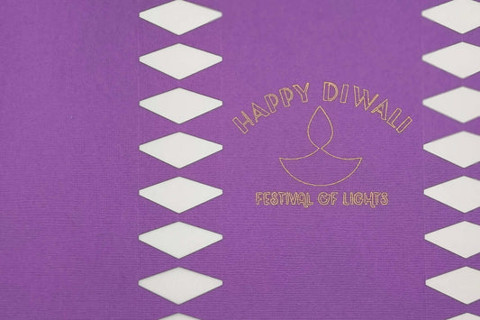 Purple cracker panel close-up showing gold foiled diya symbol with “Happy Diwali Festival of Lights” lettering.