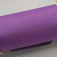Rear view of purple Diwali cracker with gold foiled “Festival of Lights” text and diya symbol.