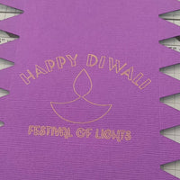 Gold foiled “Happy Diwali Festival of Lights” text with diya motif on textured purple cracker card.