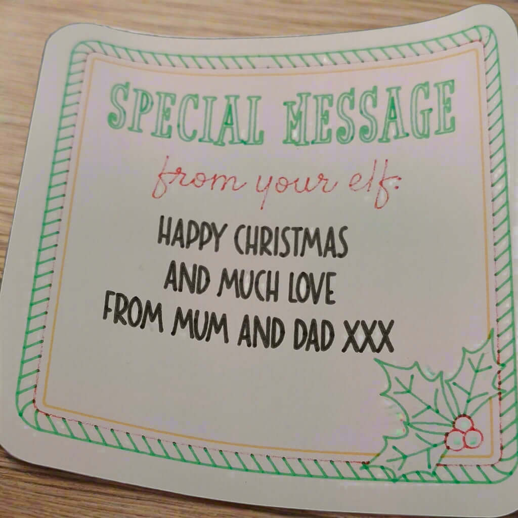 Elf Special Message Sticker with festive border and holly sprig, personalised Christmas gift label reading “Happy Christmas and much love from Mum and Dad XXX”