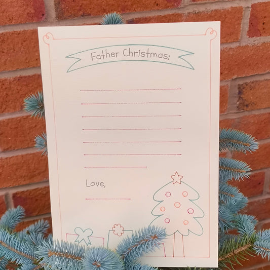 Handmade Father Christmas letter writing paper displayed on a blue spruce branch.