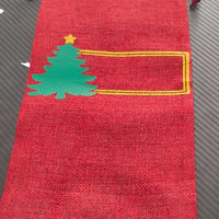 Personalised Christmas wine bottle bag in red hessian with green Christmas tree design and blank space for a name.