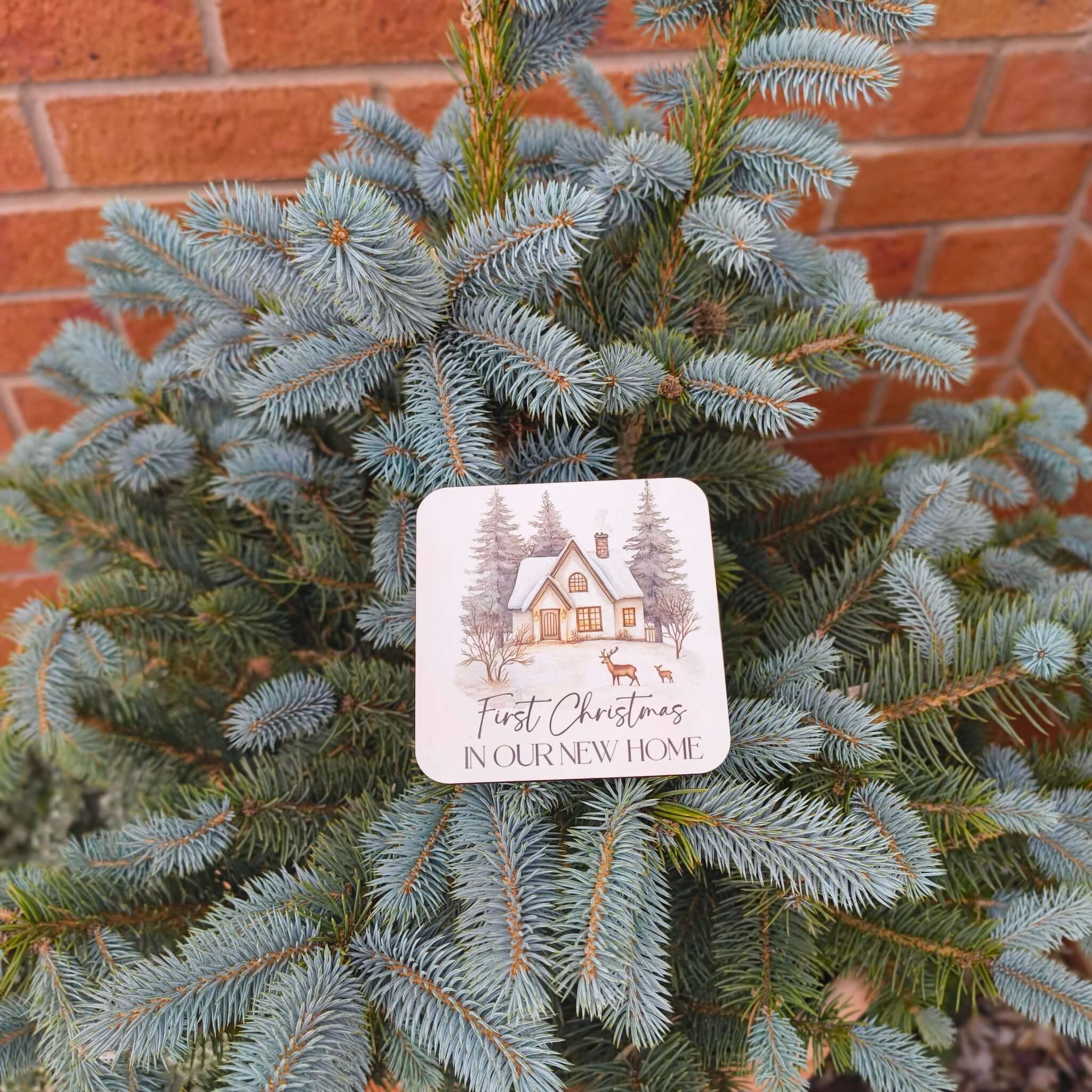 First Christmas New Home Coaster placed on a Christmas tree, celebrating a new home during the holiday season.