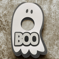 Cute ghost-shaped holder with 'BOO' text, perfect for Halloween lollipop treats.