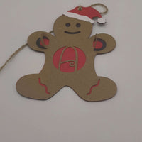 Handmade gingerbread man ornament with red monogram letter A and Santa hat, made from layered cardstock with jute string.