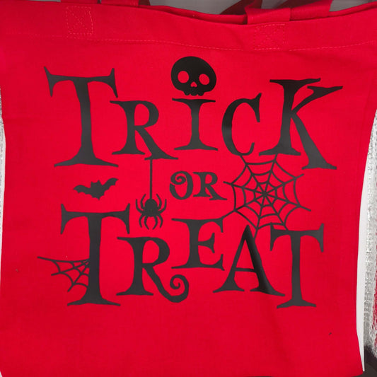 Halloween tote bag in bright red cotton with black spooky Trick or Treat design featuring spider, skull and bat details.