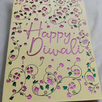 Detailed view of Happy Diwali handmade greeting card with pink cut-out lettering and floral designs, layered with green accents.