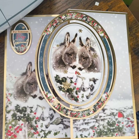 Handmade donkey Christmas card featuring two donkeys in a snowy scene with gold foiling, perfect for someone very special.