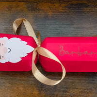 Personalised red Christmas cracker with Santa design and gold ribbon, featuring the name Barbara.
