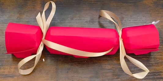 Personalised red Christmas cracker with gold ribbon, perfect for adding a festive touch to your holiday table.