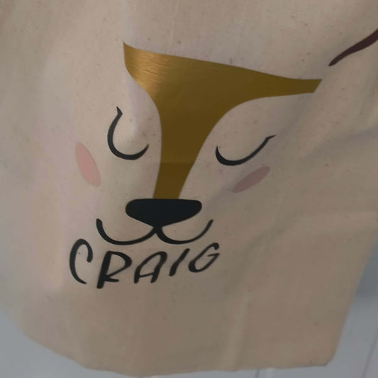 Personalised reindeer gift sack featuring gold foil design and the name 'Craig', perfect for Christmas gifts.