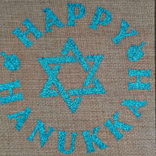 Centre view of Hanukkah drawstring gift bag with blue glitter text and festive icons