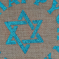 Close-up of glittery blue Star of David on Hanukkah hessian gift bag
