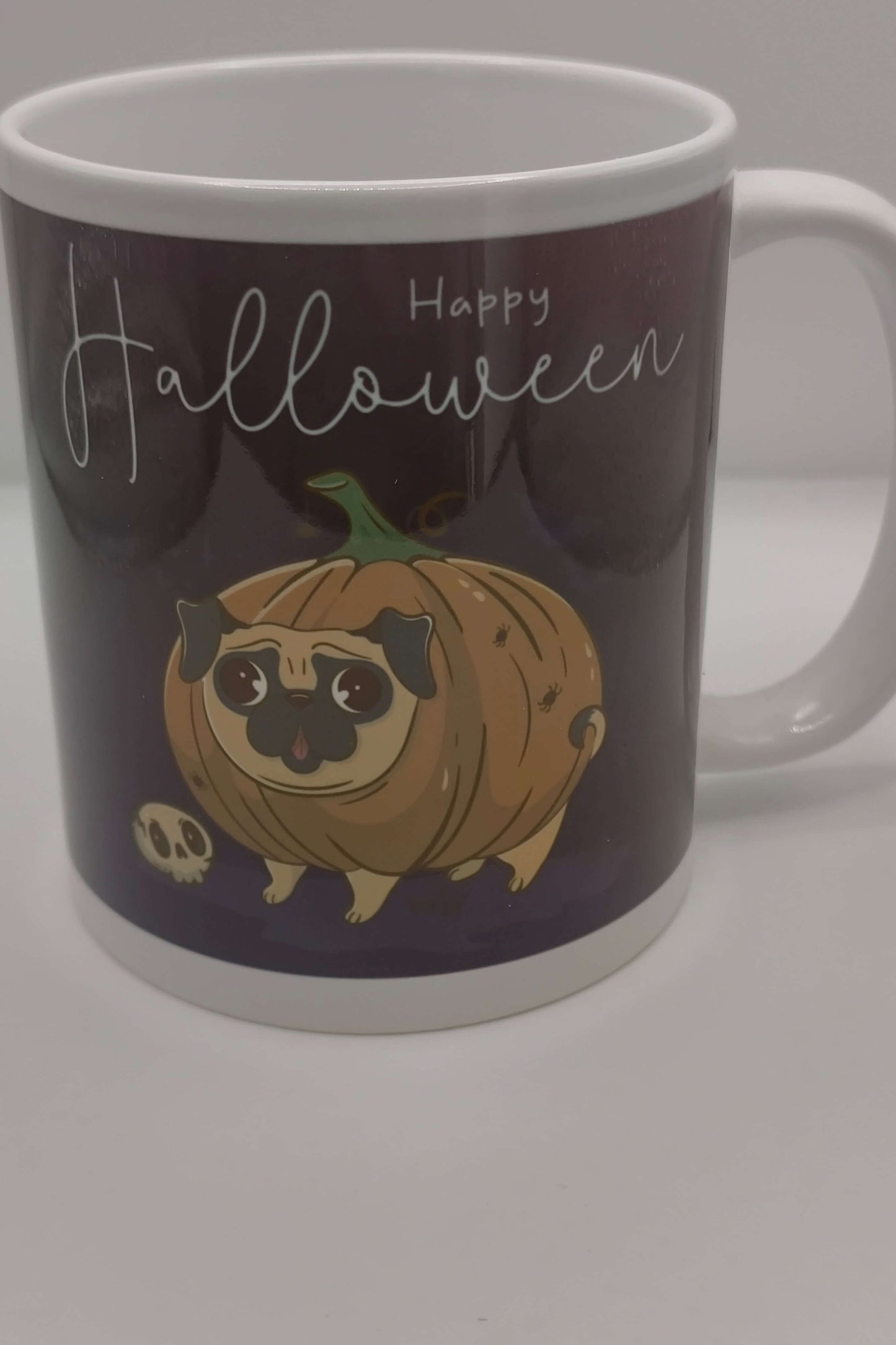 Happy Halloween mug showing cartoon pug dressed as a pumpkin, perfect autumn coffee mug or Halloween gift for dog lovers.