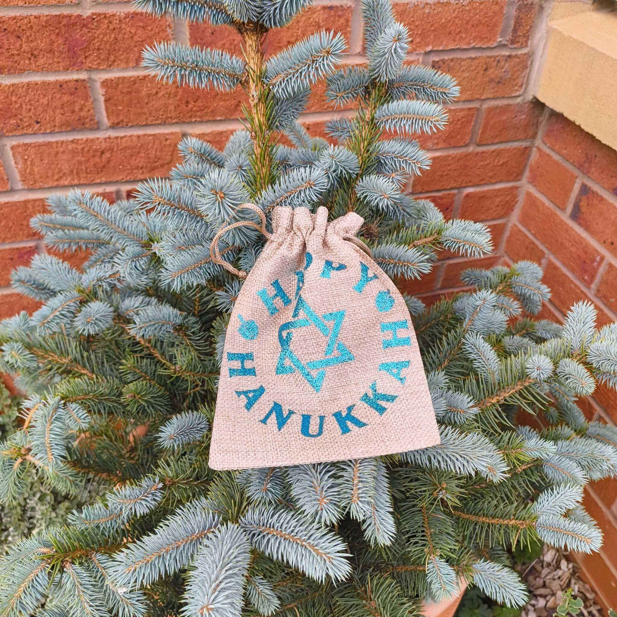 Hanukkah drawstring bag with Star of David hanging on a pine tree.